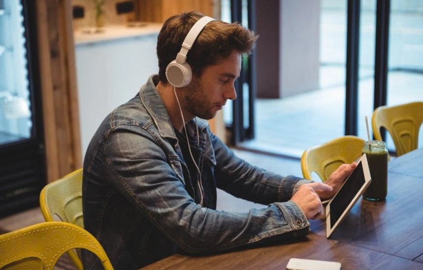 Creator producing AI narrated audiobook with headphones