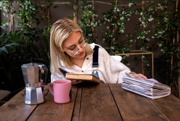 Woman reading book at café