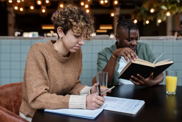 Students studying together while taking detailed notes